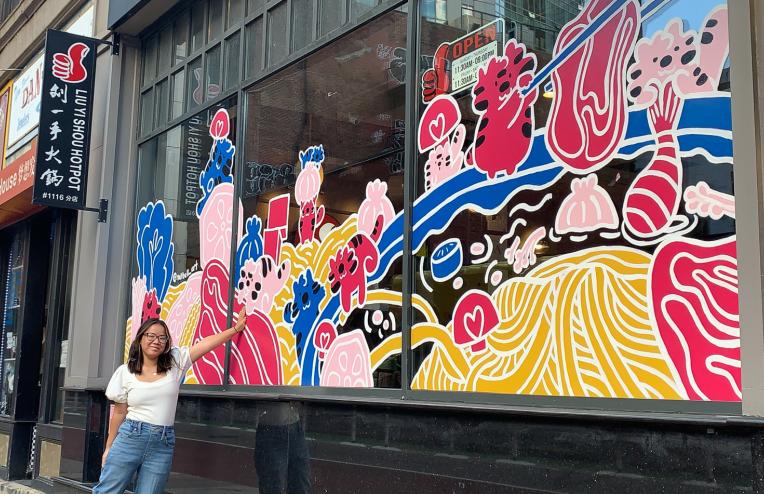 Nell Valle in front of her mural in Chinatown