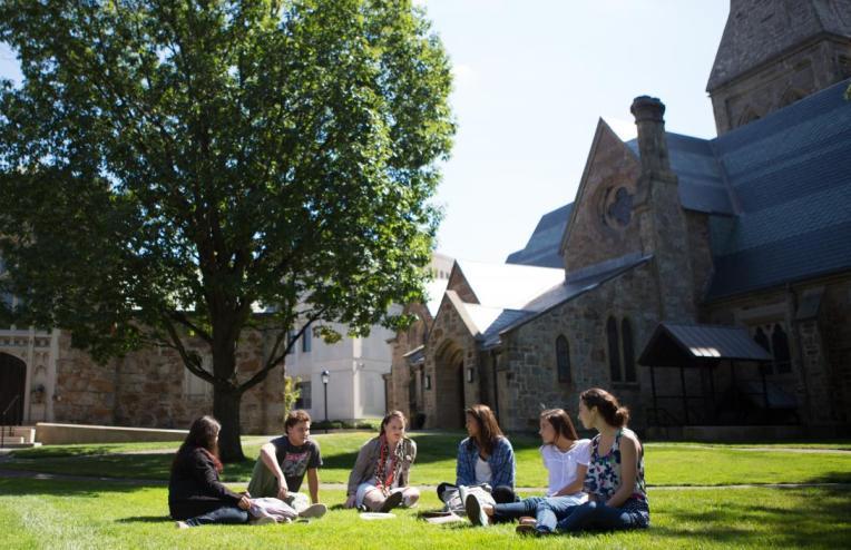 Students in an arc, chatting on Lesley's lawn.