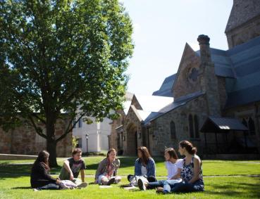 Students in an arc, chatting on Lesley's lawn.