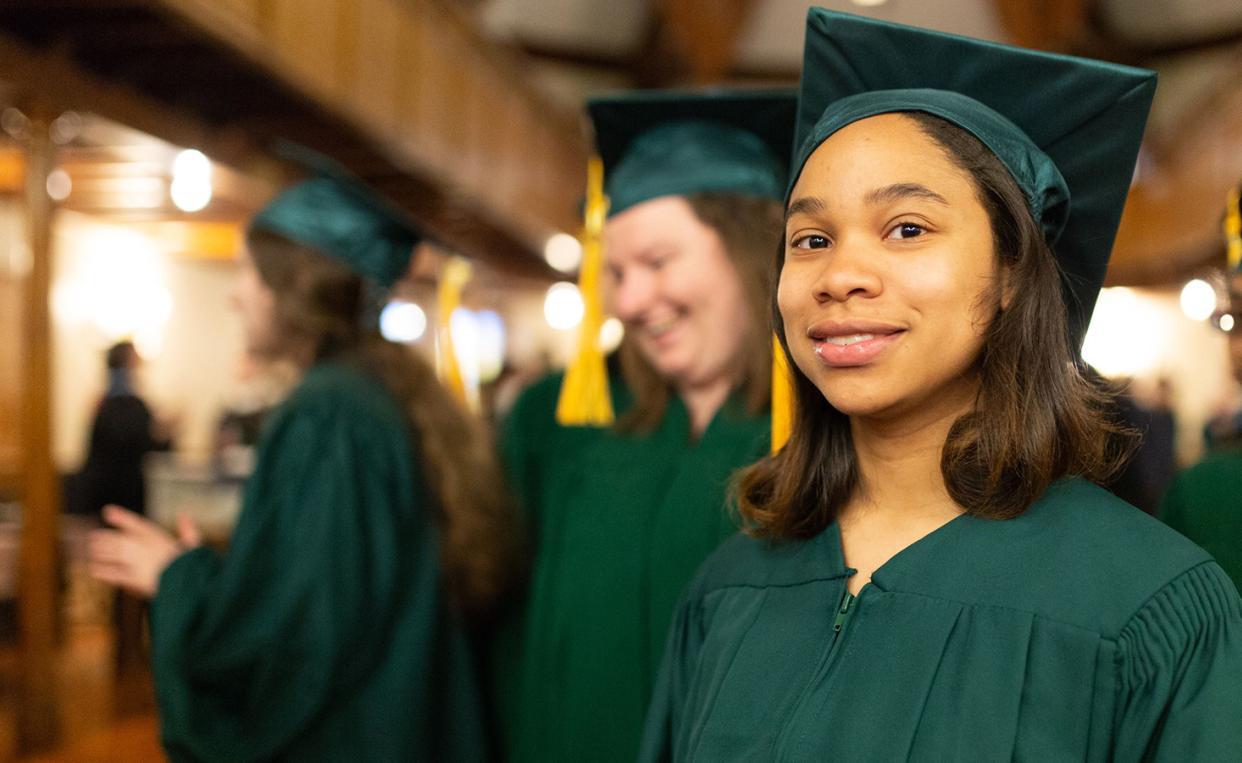 Lesley University smiling graduate in Threshold Program commencement