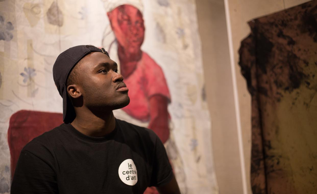 Rocky postulating in front of his artwork