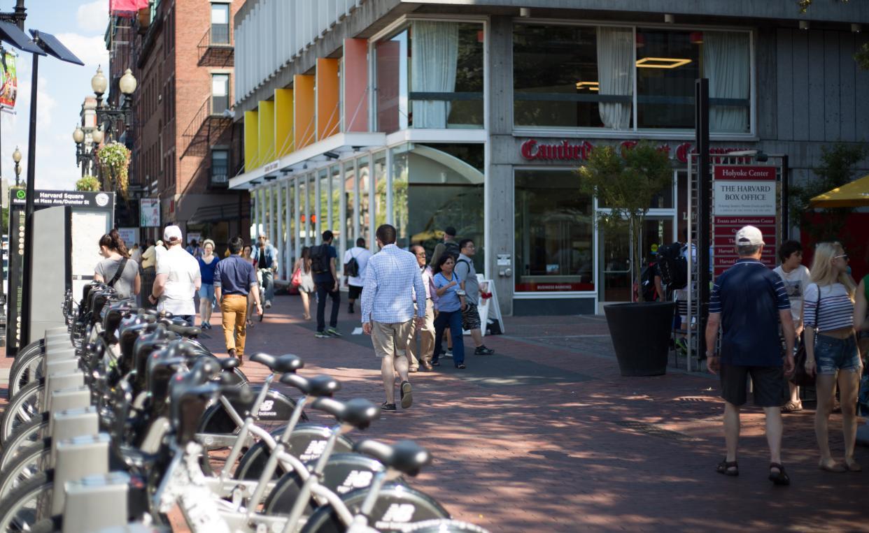 man walking in harvard square, cambridge