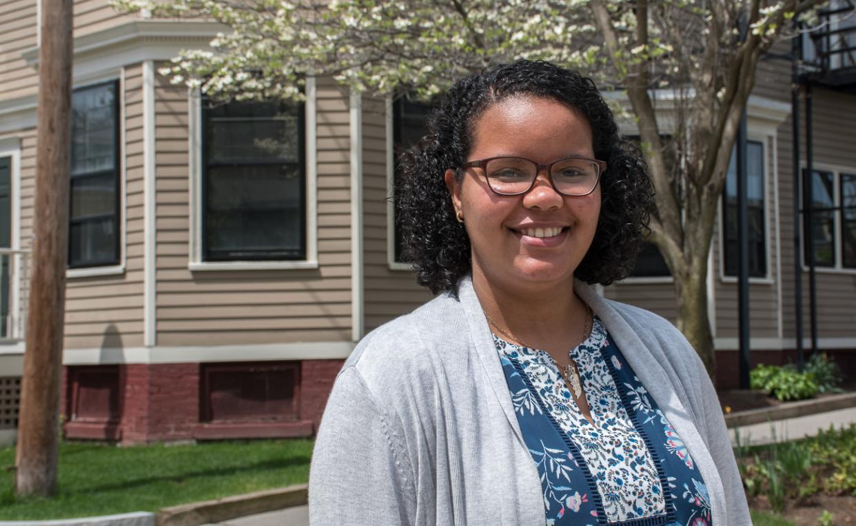 Leonela Ramirez-Trejo on Doble campus with flowering tree behind her.