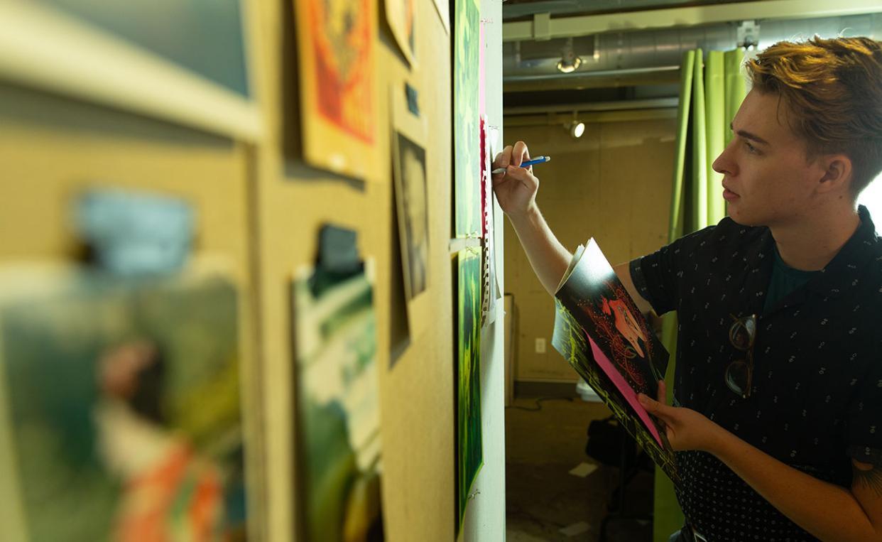 student working on art in studio