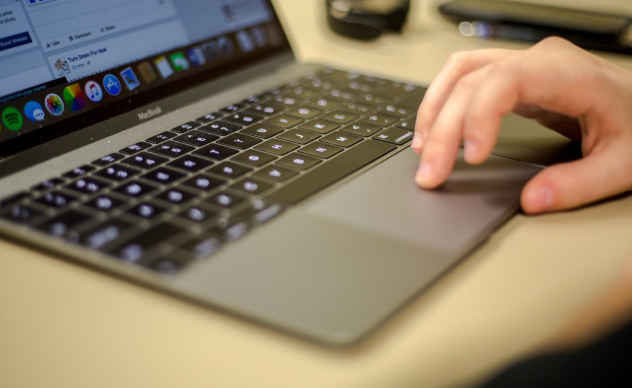 hand on laptop computer