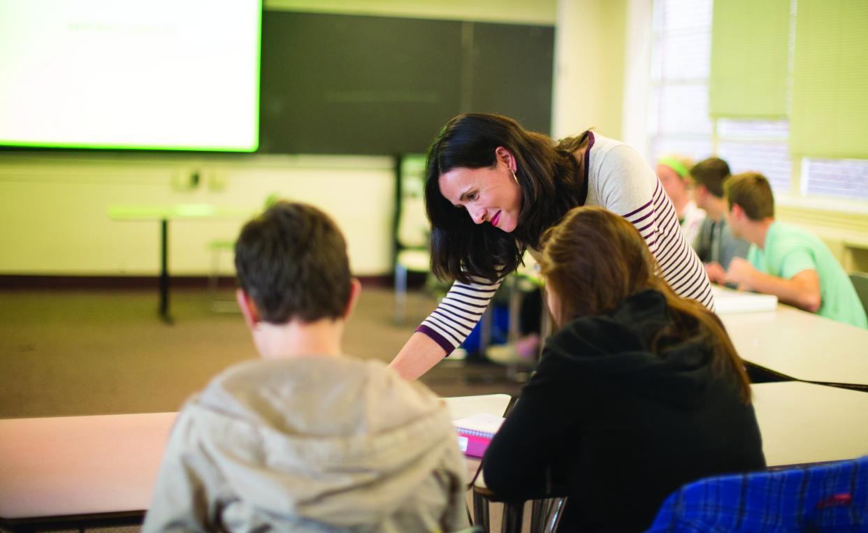 classroom teacher with students at table