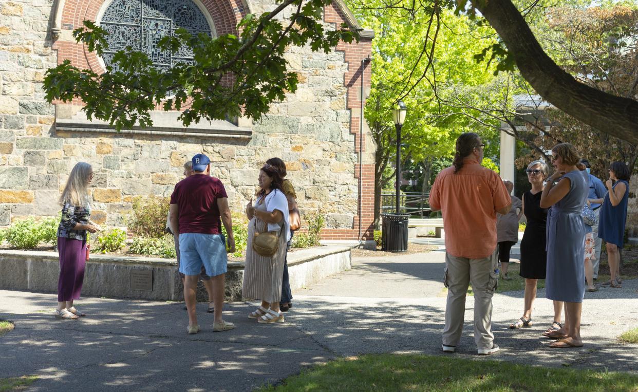 A group of students mingling outside Sherrill Library.