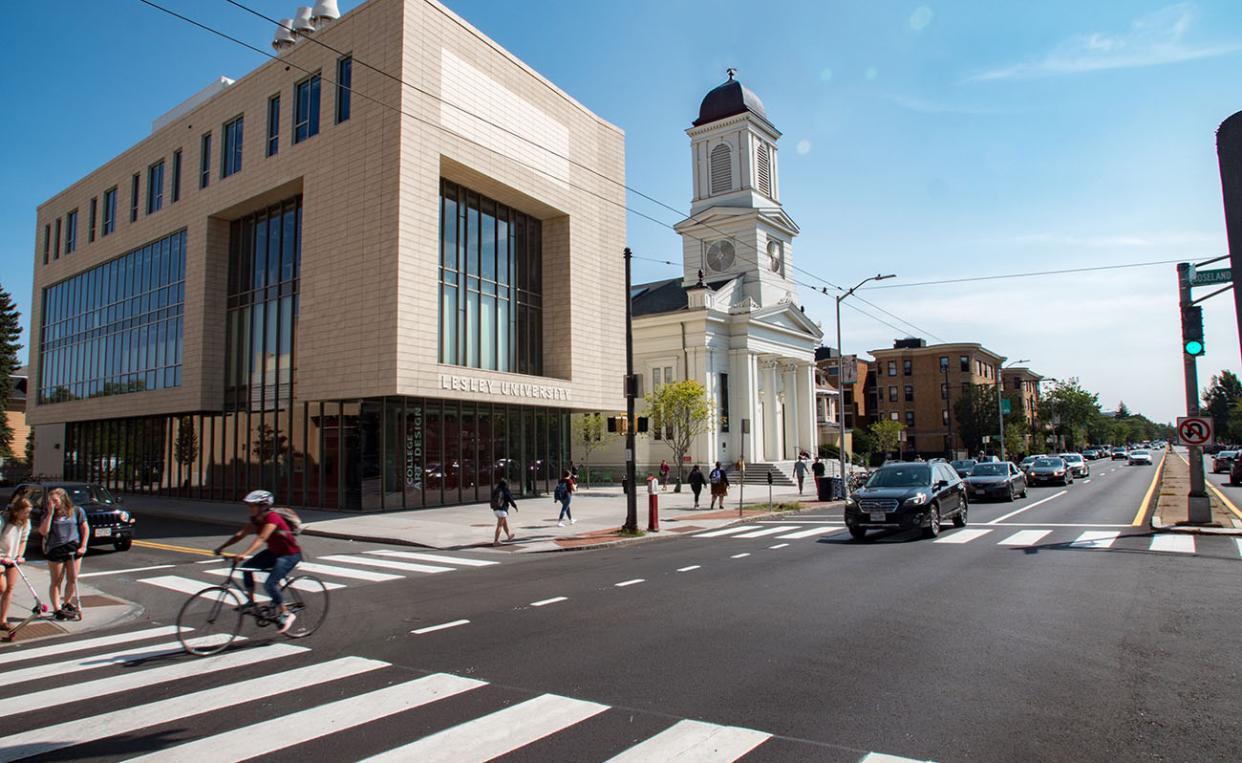 photo of lunder arts center and church along a busy inresection under a clear blue sky