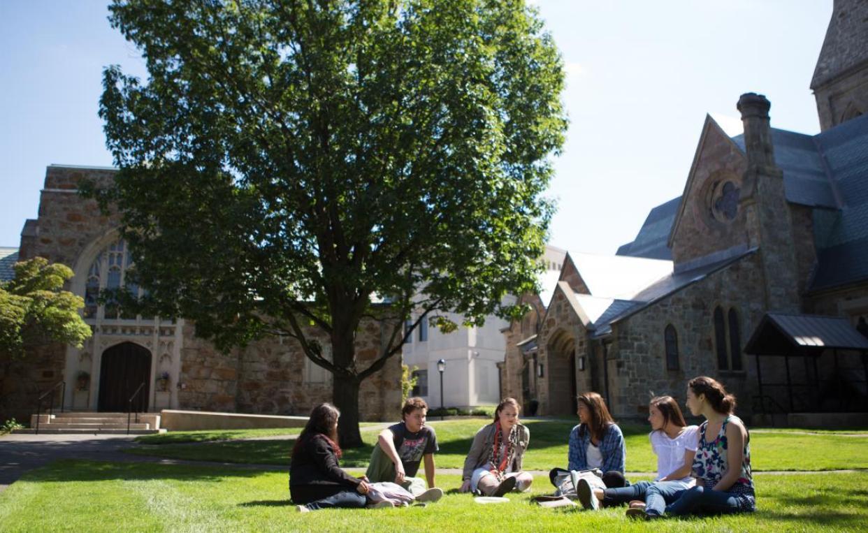 Students in an arc, chatting on Lesley's lawn.