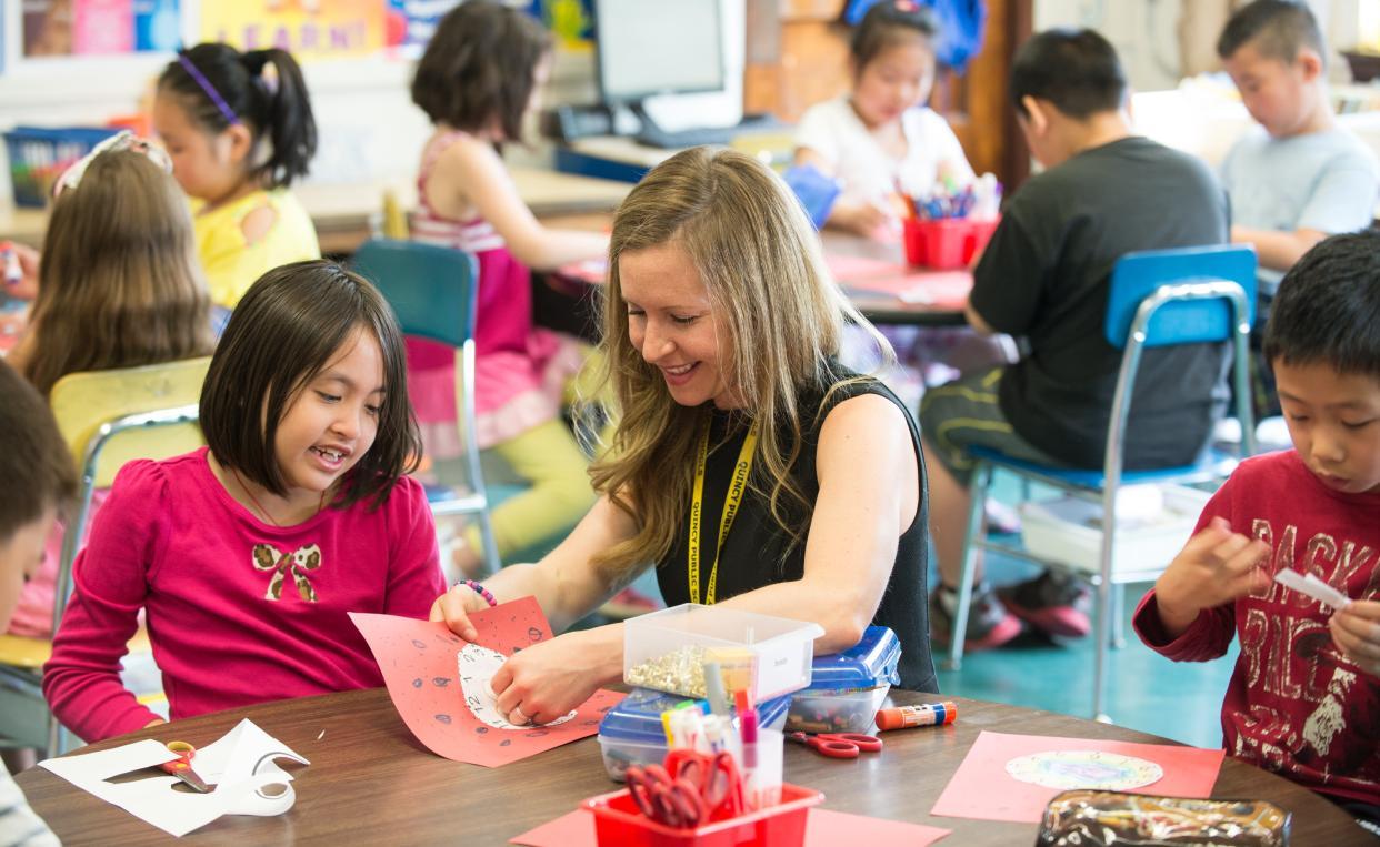 teacher doing art and crafts with a student