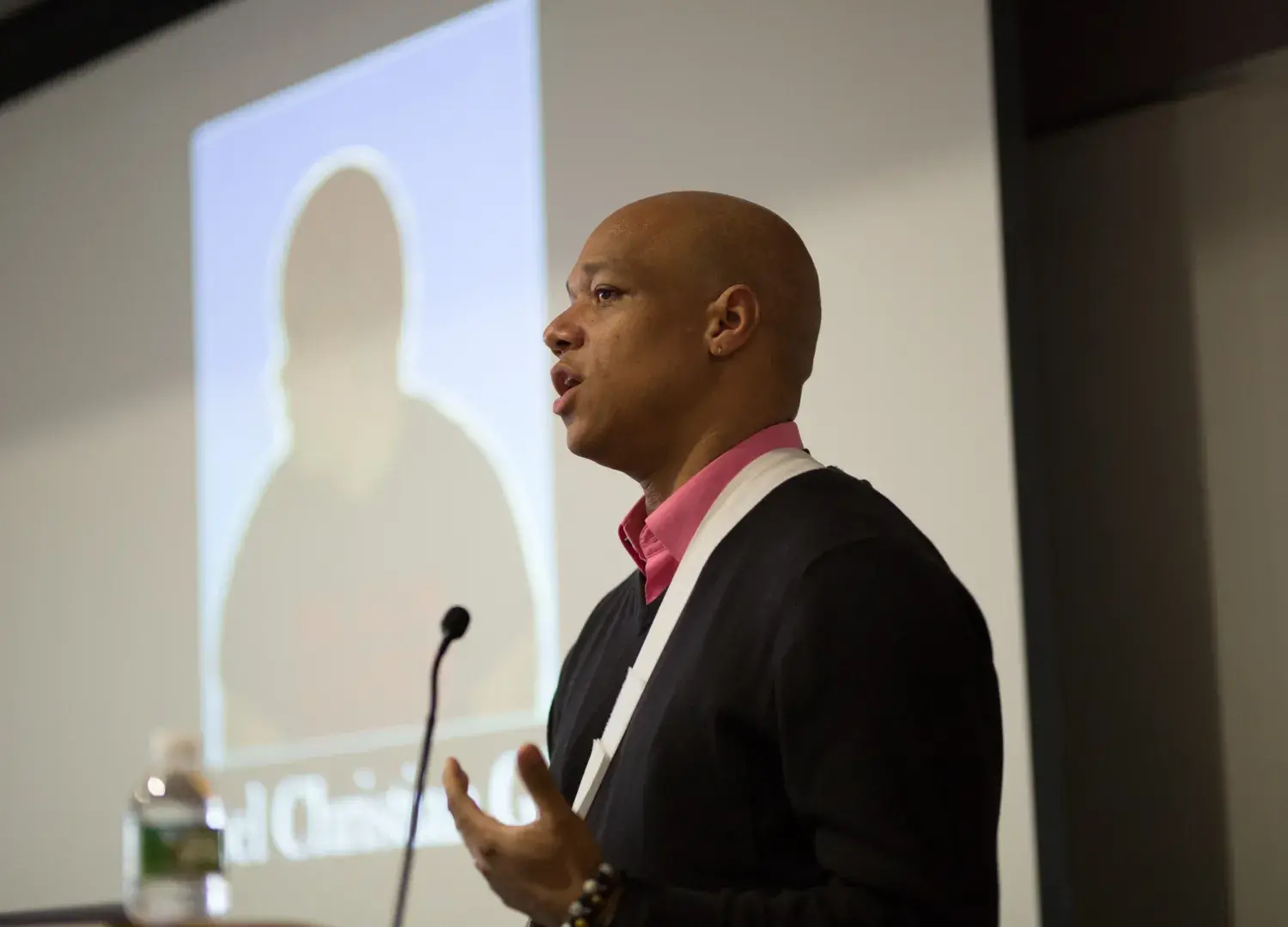 Joel Christian Gill speaks while standing at a podium.