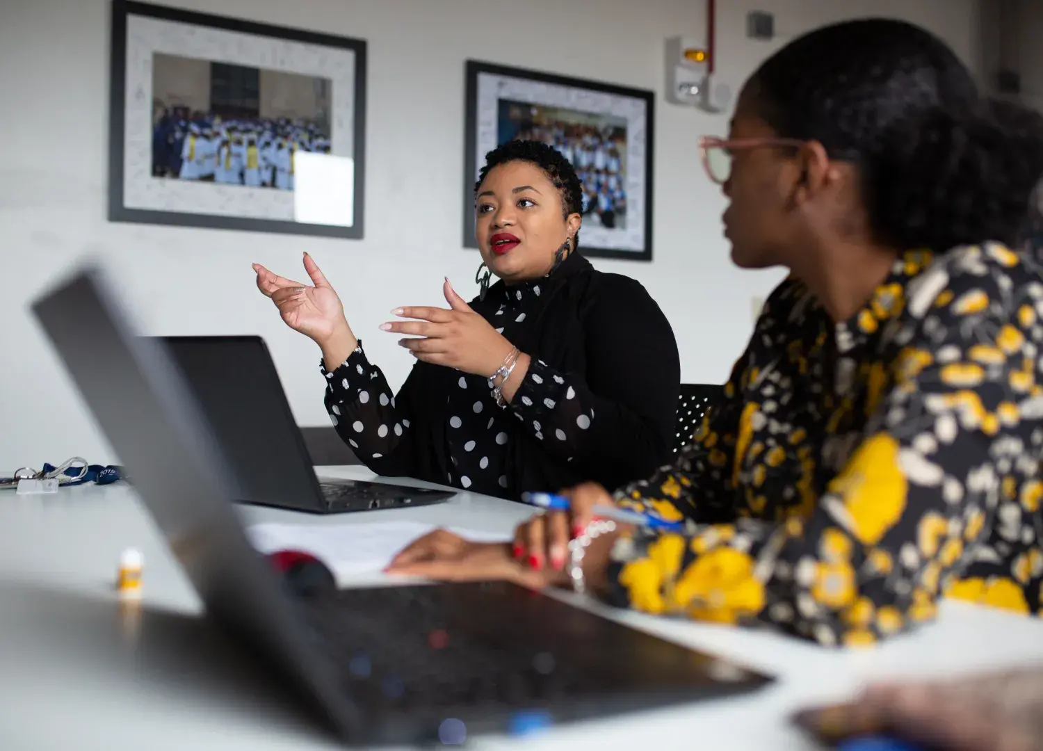 Myisha Rodrigues working with colleagues at a shared desk