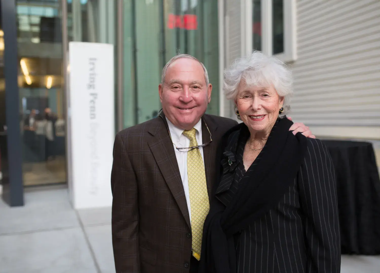Peter and Paula Lunder pose in front of the Lunder Arts Center