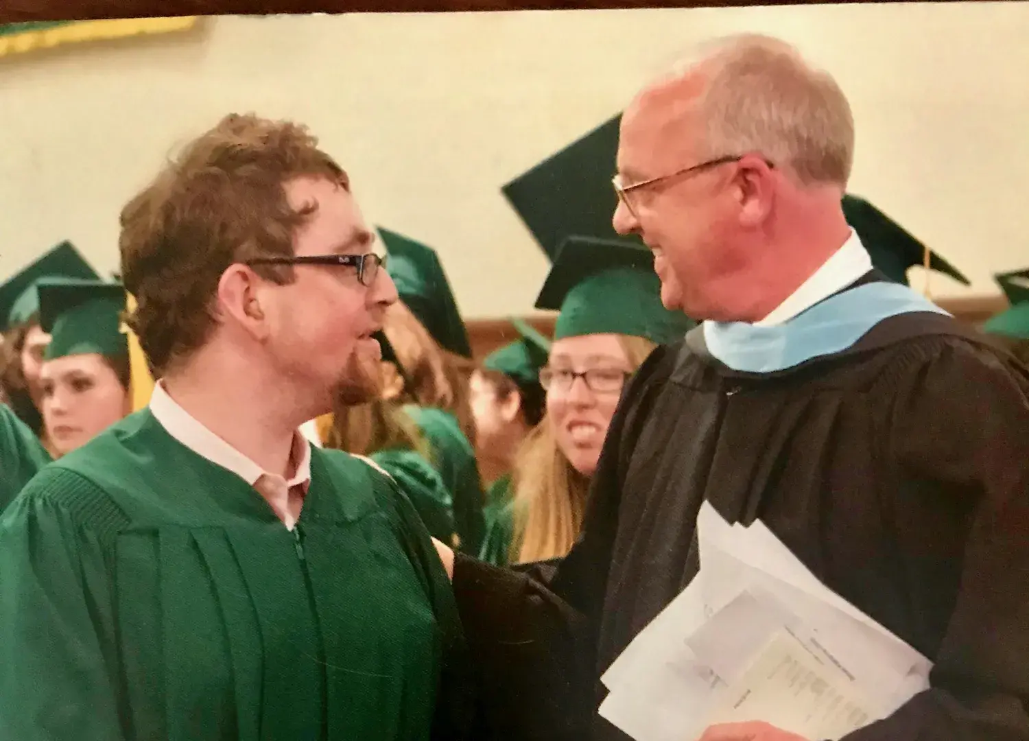 Daniel Dubinsky and Jim Wilbur in academic regalia at Threshold graduation