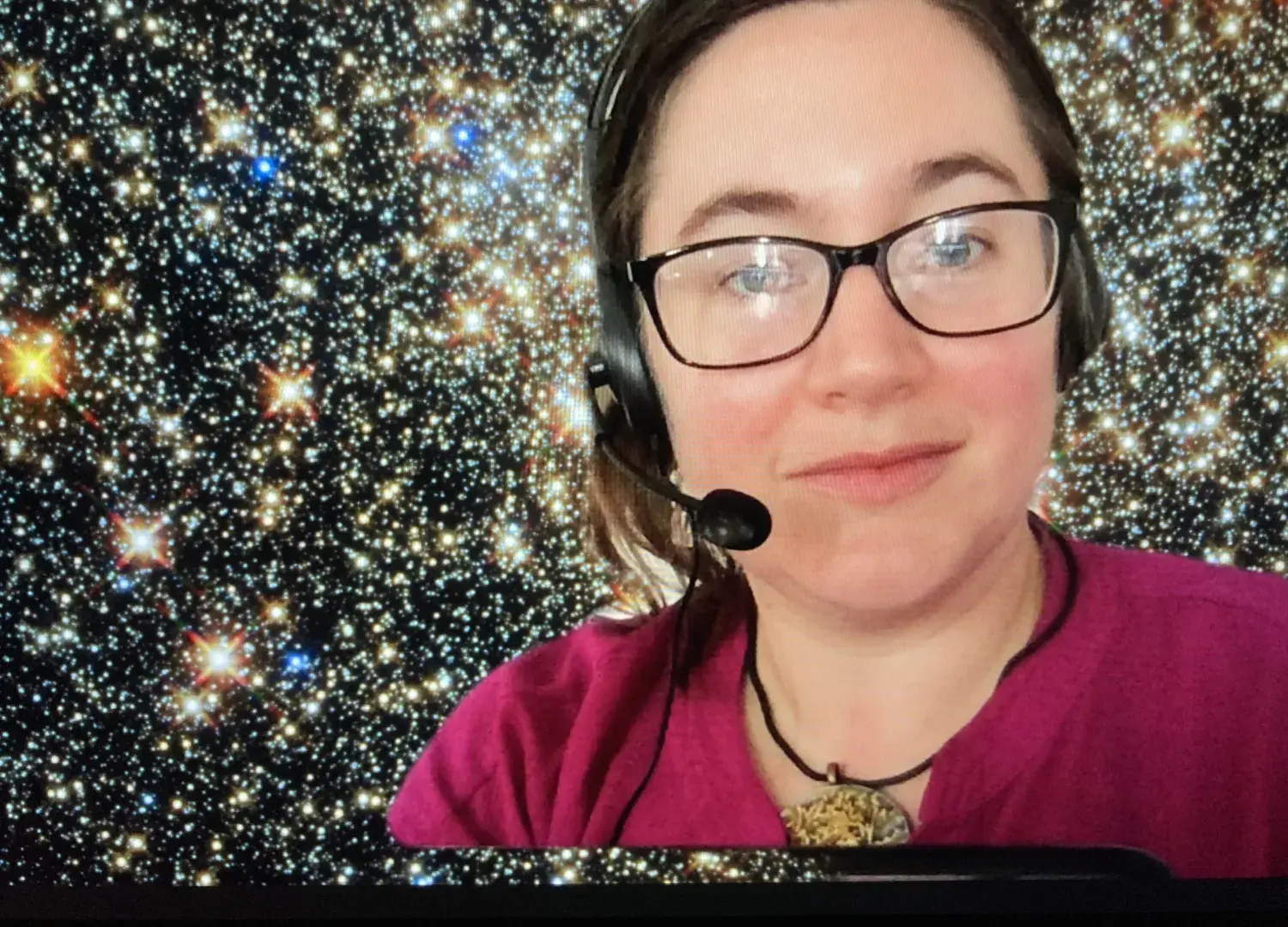 Photo of Giuliana Funkhouser wearing gaming headset in front of starry background