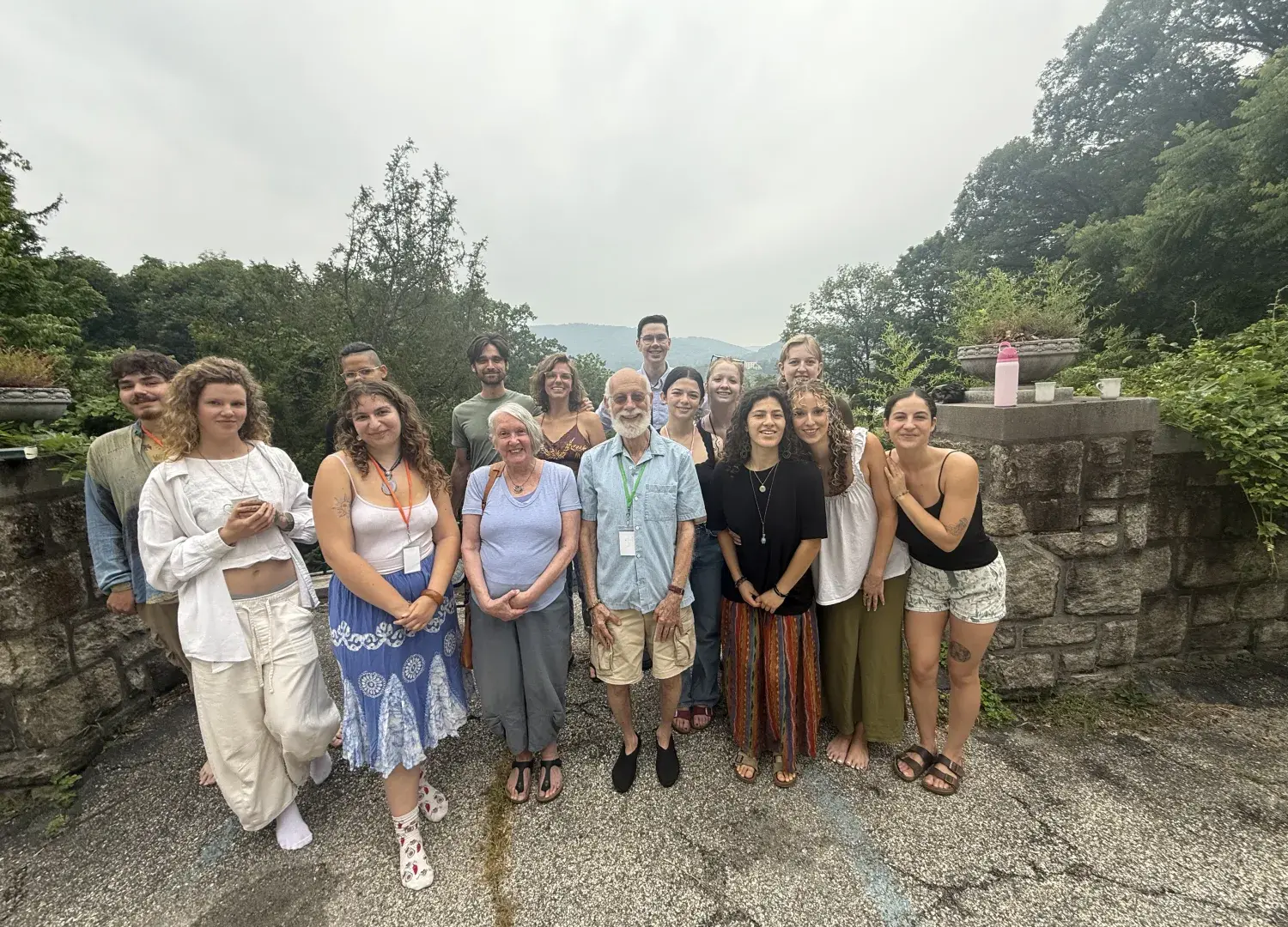 people standing in front of a rock wall