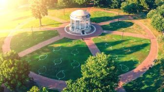 Aerial of Boston Common with view of grass that has leaves painted on it to guide for social distancing.