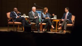 panel of speakers sitting on stage at Boston speaker series on racism