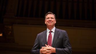 James Comey standing on the Symphony Hall stage