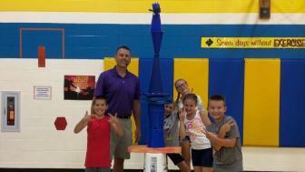Chris Wendorf with kids in a gym.