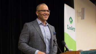 Christopher Jackson stands at the podium smiling.