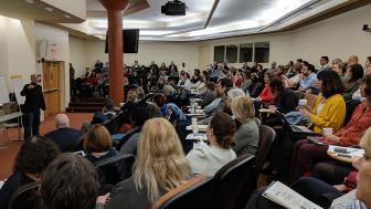 Audience of more than 100 people at University Hall Amphitheater
