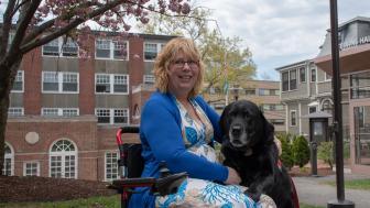 Dee Genetti and her service black lab service dog