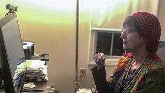 Donna Halper sitting in her office in front of a computer