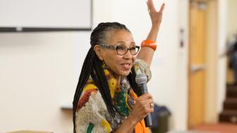 Rev. Gloria White-Hammond speaks. holding her left hand up.
