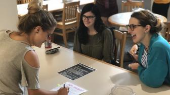 Students pictured staffing an information table in White Hall dining hall.