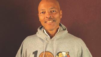 Jerry smiling wearing a sweatshirt that says "1 Newbery"