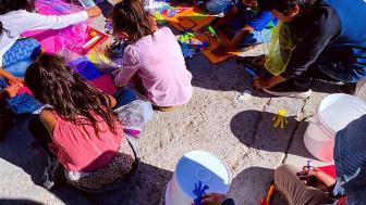 Kids sitting on the floor drawing