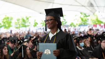 Julette Moore holding her degree at the 2022 Commencement Afternoon Ceremony.