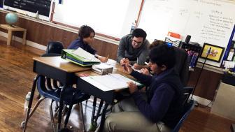 Alumnus Kevin DeCosta teaches students in his social studies classroom