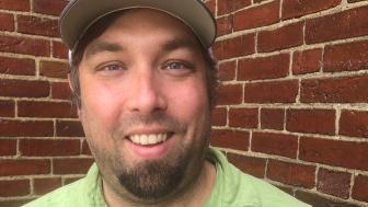 Kevin Heinold headshot wearing a lime green shirt.