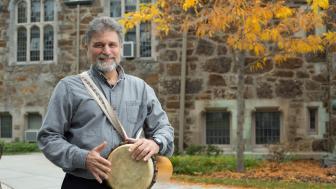 Kossak holds a drum on campus.