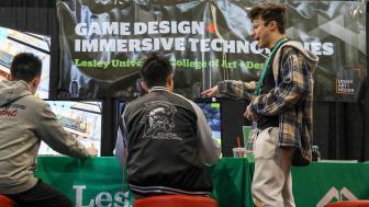 Student Jake Anderson shows PAX attendees a game built at Lesley