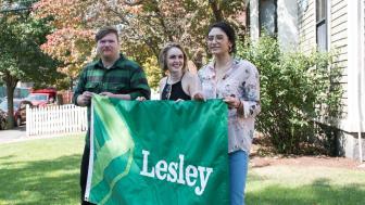 Students Michael Coleman, Raine Ferrin and Christine Lopez Corado hold the new Lesley flag that they designed.