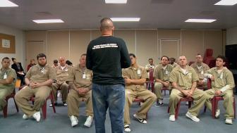 Louis Diaz speaks to a room full of prisoners.