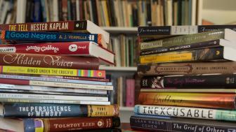 Two stacks of books on a table