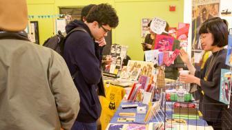 Students and artists presenting at a comic book convention