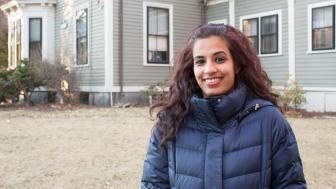 Outdoor shot of Mariya Taher in front of 29 Everett (founder's house at Lesley).