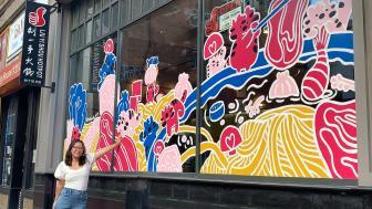 Nell Valle in front of her mural in Chinatown