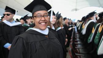 Tamara Adams smiles for the camera in her Commencement regalia