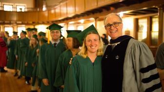 Graduates line up behind Threshold Director Ernst VanBergeijk before they process into the ceremony.