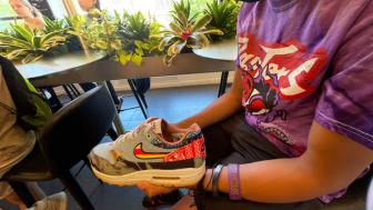 A student examines a Nike sneaker.
