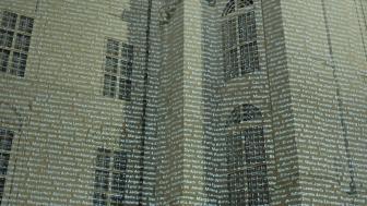 Thousands of names are projected onto a building.
