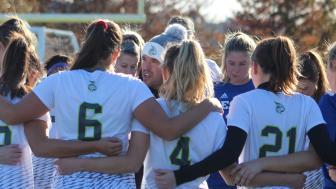 Coach Paul Vasconcelos amid player huddle