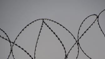 Barbed wire at the top of a fence