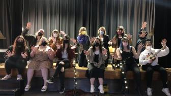 Photo of cabaret cast posed on the Washburn Auditorium stage
